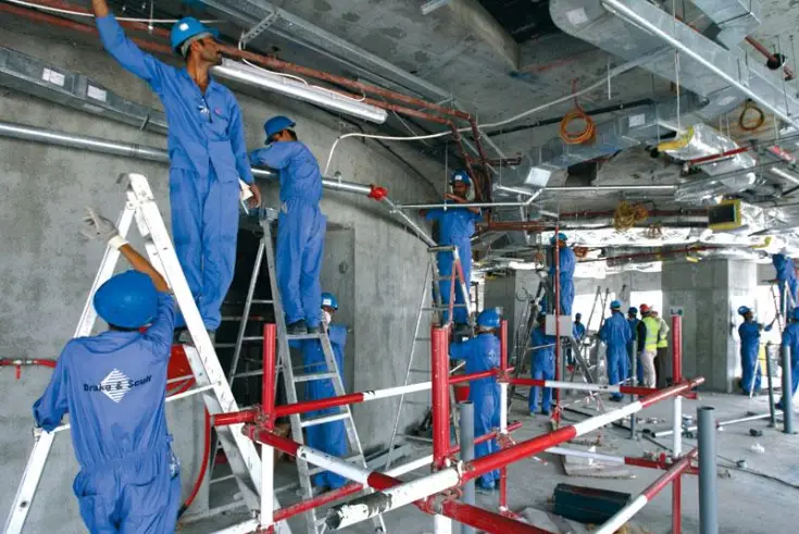 workers-servicing-heavy-industrial-machines